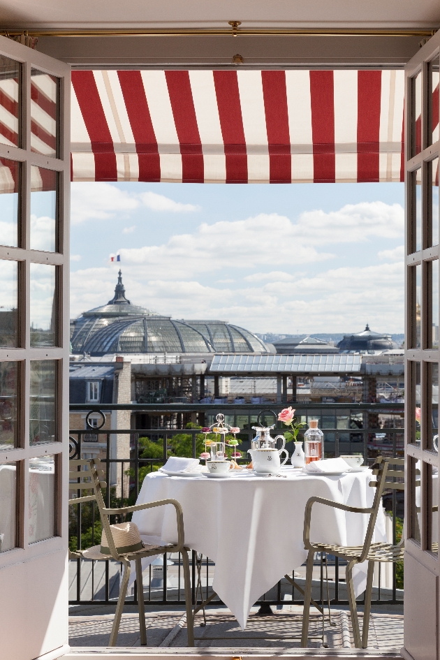 room balcony with table and chairs on with views of france on sunny day